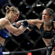 Amanda Nunes, right, connects with Ronda Rousey in the first round of their women’s bantamweight championship mixed martial arts bout at UFC 207, in Las Vegas.